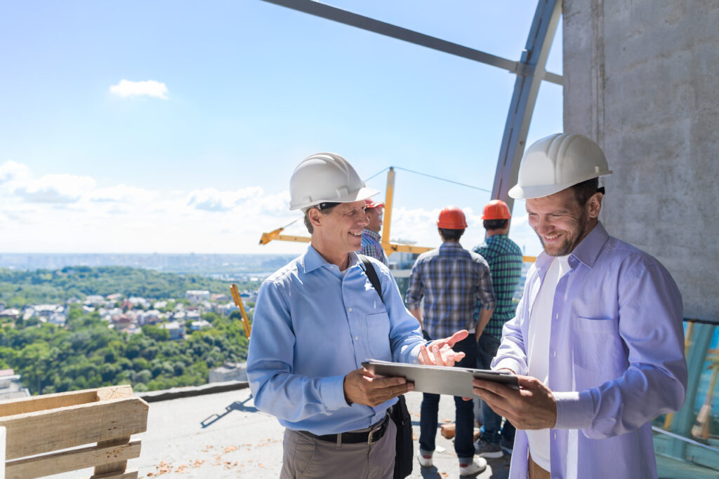 Architect Explain Project Plan To Builder Contractor On Constuction Site